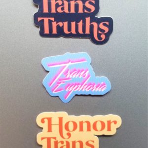 Three stickers. One is dark blue vinyl sticker that says Honor Trans Truths in an deep coral embellished font. The second is light blue vinyl stickers that say Trans Euphoria in bright white scrawling text with a bright pink shadow. The third is a cream colored vinyl sticker that says Honor Trans Truths in an burnt orange embellished font.