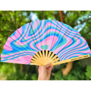 Photo of a psychedelic swirl clack fan in blue, pink, and light teal.